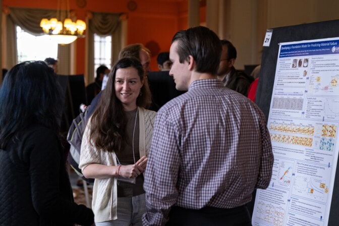 Two women and a man discuss the project "Developing a foundation model for predicting material failure."