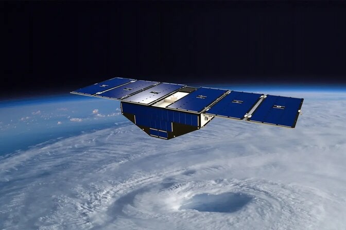 Blue triangle with wings in space over a circle of clouds.