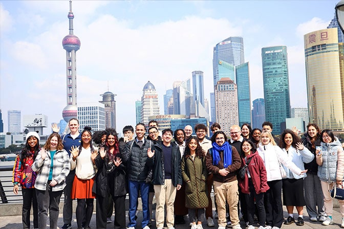 Martin E. Chavez poses with a group against the cityscape