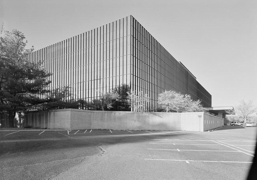 A modern, cube-shaped office building in black and white.