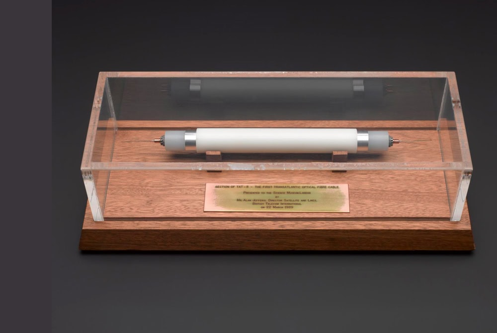 A horizontal plastic cylinder inside a clear plastic display case.