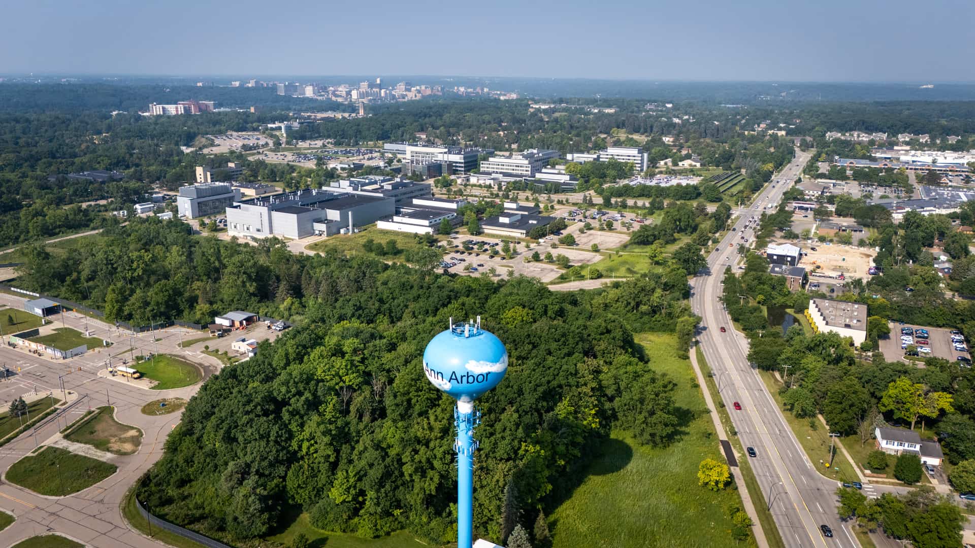 An aerial photograph shows a cluster of office buildings and a water tower.