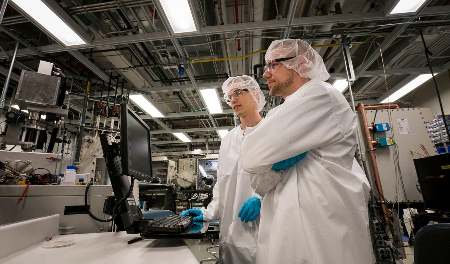 Two young men work in a laboratory.