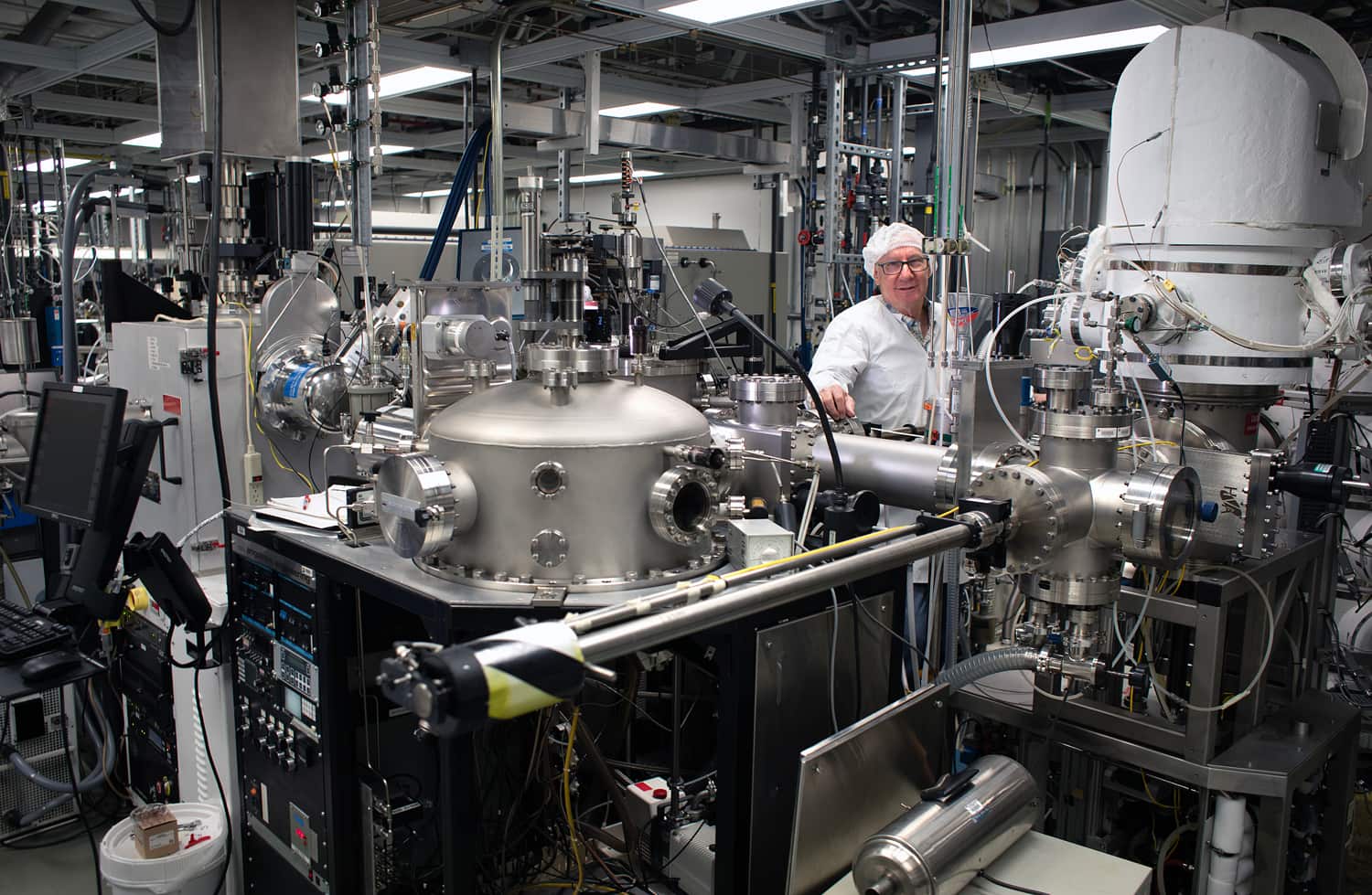 A man in a laboratory looks directly at the camera.