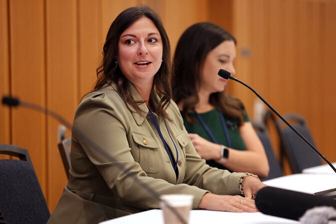 Pauline Wendzel sits in a panel discussion at the forum, engaged in conversation.
