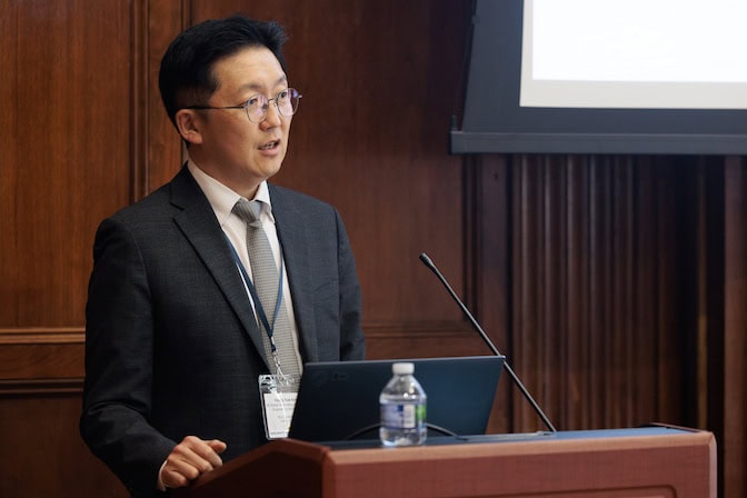 A man speaks at a podium.