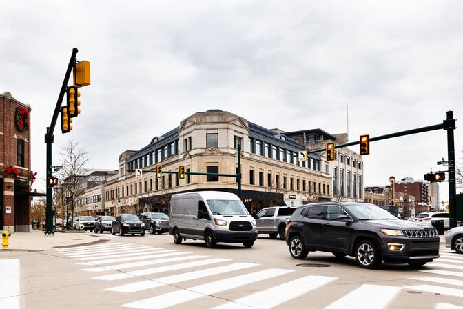 Vehicles are seen passing through a busy downtown intersection.