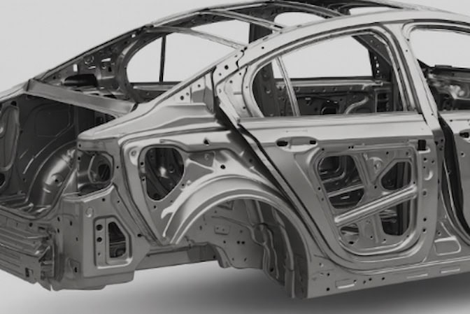 The metal frame of a car body without external panels or paint.