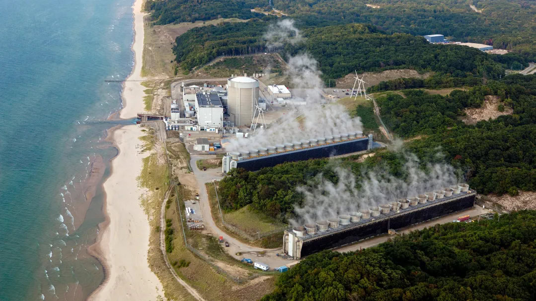 aerial view of nuclear power plant situated on a lakeshore