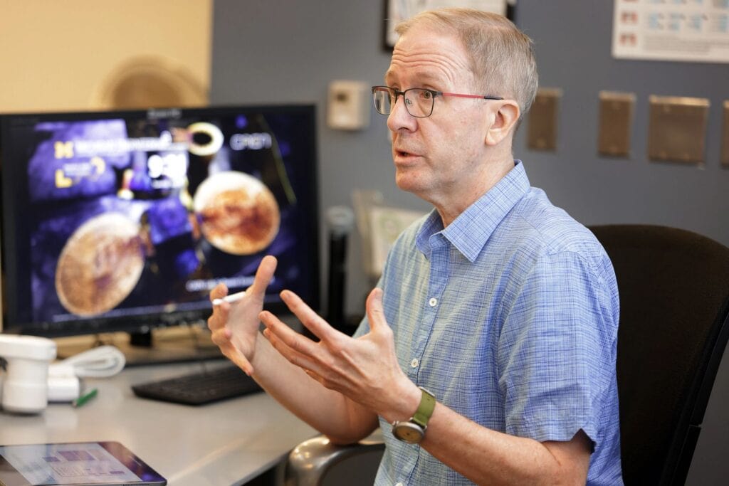 A professor uses his hands as he explains during an introductory lecture during week one of the Harper Academy 4 Future Nuclear Engineers program.