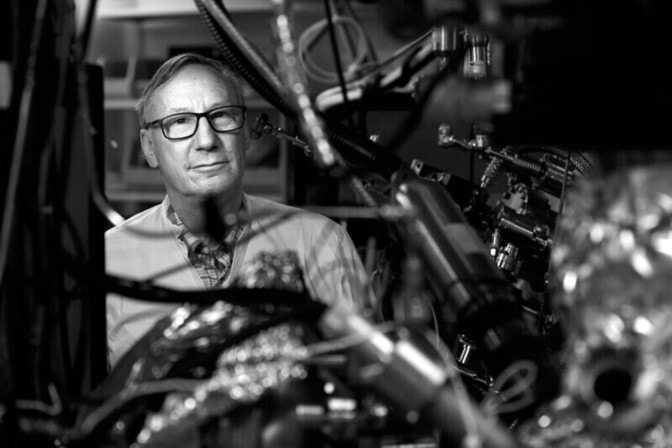 Steve Forrest poses for a portrait among chambers and technology that deposits thin films for organic light emitting devices in his lab of the Optoelectronic Components and Materials Group at the Electrical Engineering and Computer Science building.