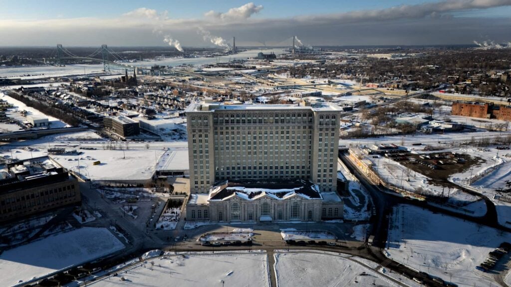 A large and tall building towering above the area, covered in snow.