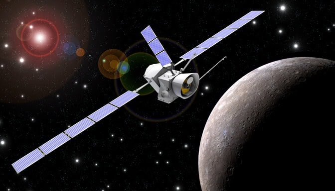  a spacecraft flies in space. A brown-gray planet is visible behind the spacecraft. Stars speckle the blackness of space.