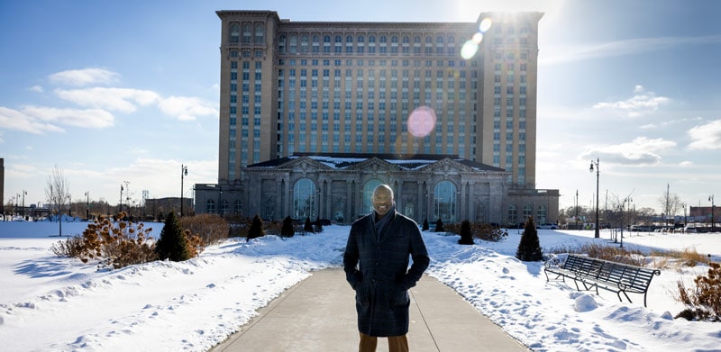 Larry Brinker standing in front of Michigan Central Station in Detroit, Michigan.