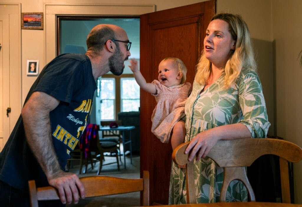 Julianne Lyon talks to family members while holding their young daughter inside the farmhouse. Chris teases the daughter.