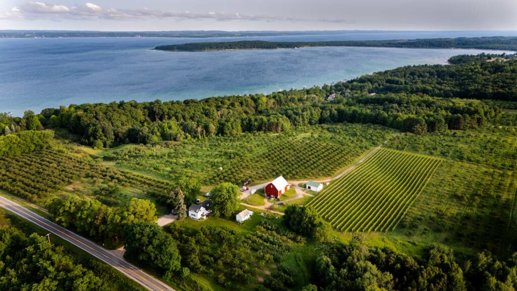 Aerial view of Lyon Farm & Vineyards overlooking Grand Traverse Bay and surrounding orchards and vineyards.