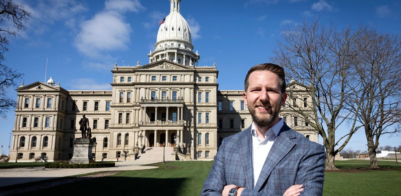 Ben Marchionna stands in front of the Michigan state Capitol building in Lansing, Michigan. 