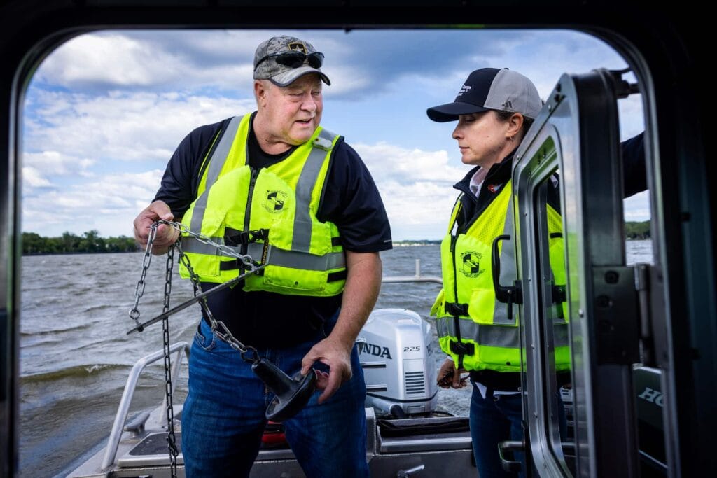 Two researchers converse on the deck of a survey boat during a Lake Michigan field study.
