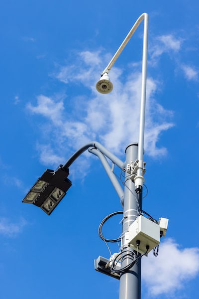 Sensors and cameras are seen attached to a high pole at an intersection.